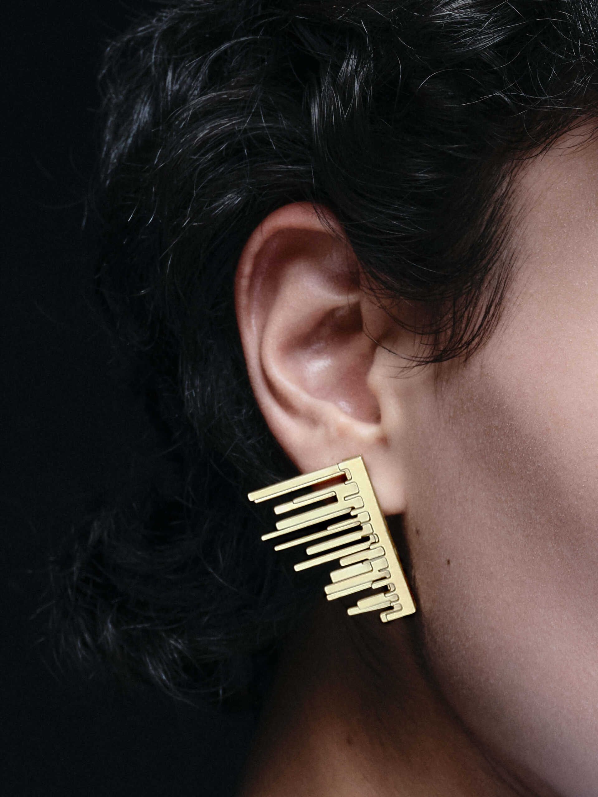 Close-up detail of the Starr Wing earrings displayed for the campaign
