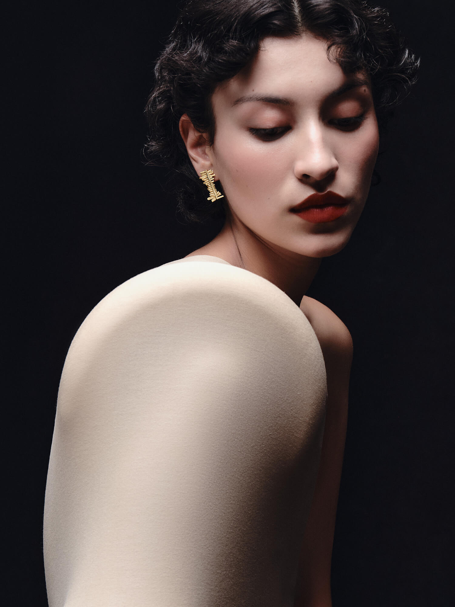 Model wearing the Starr Skeleton earrings in a campaign shot